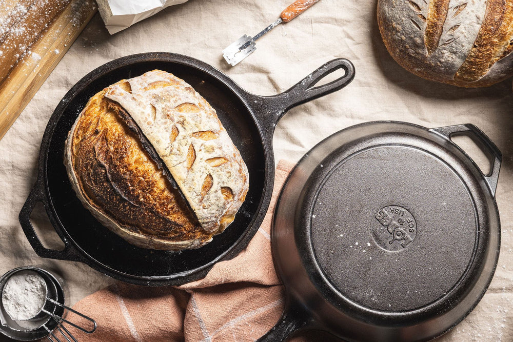Fresh sourdough bread presented in combo cooker skillet.