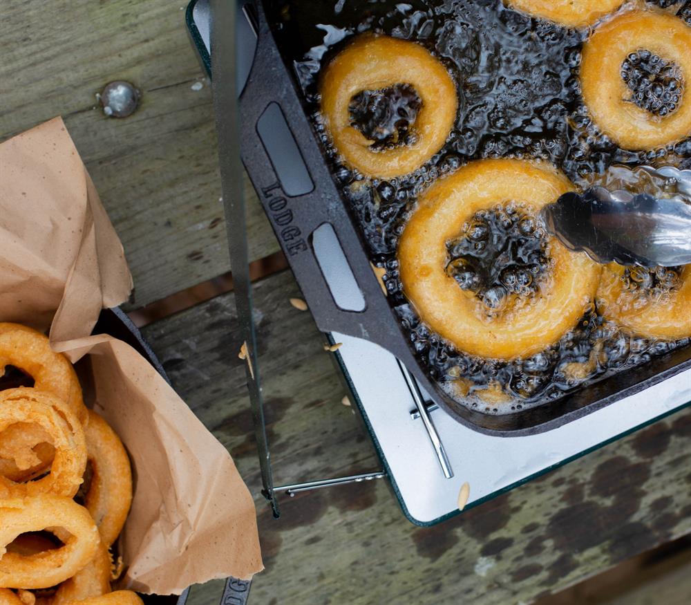 Onion rings being fried in fish pan