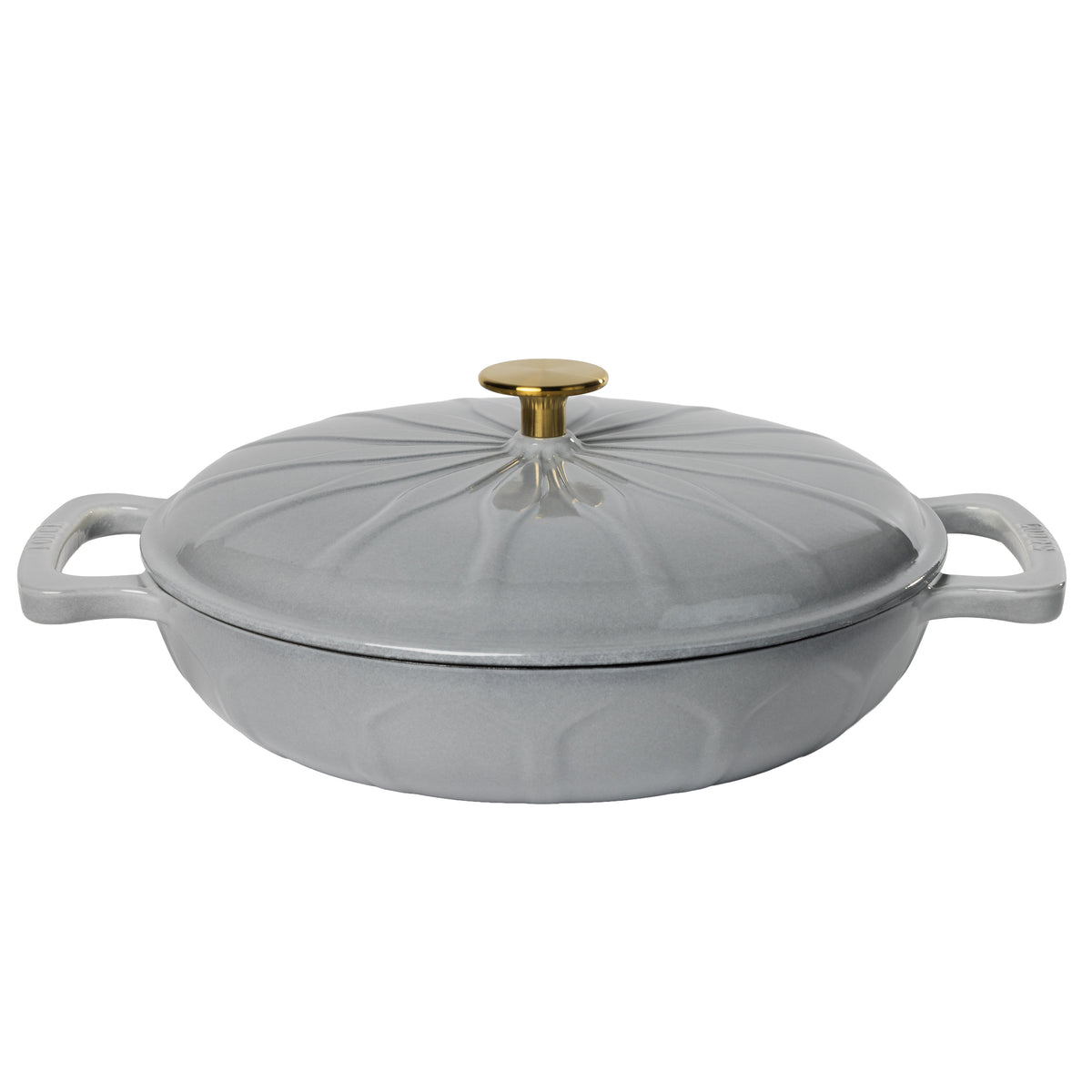 A light gray enameled cast iron lidded casserole dish with side handles, a gold-tone knob, and a sunburst pattern.