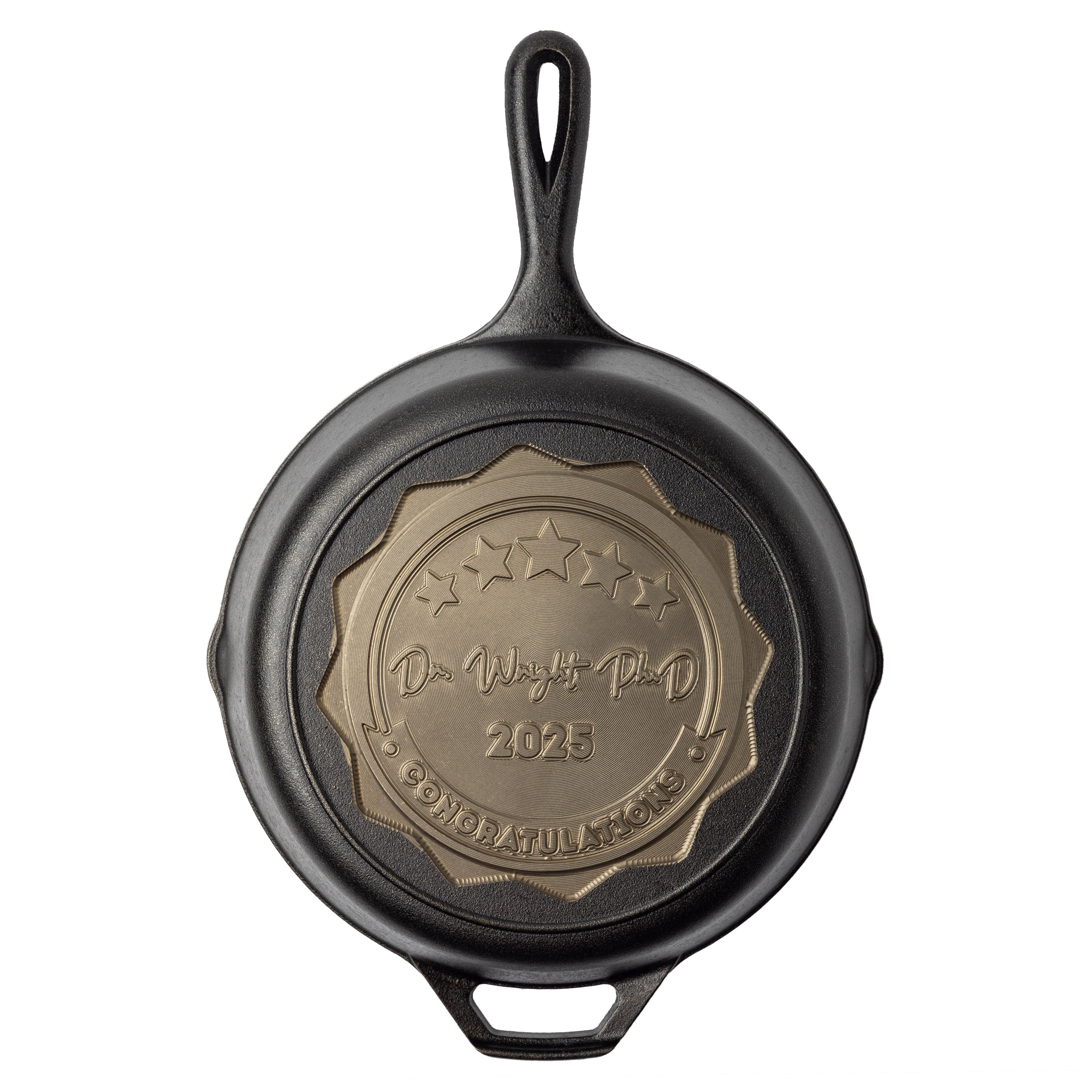 Black cast iron skillet with a engraved badge on a white background