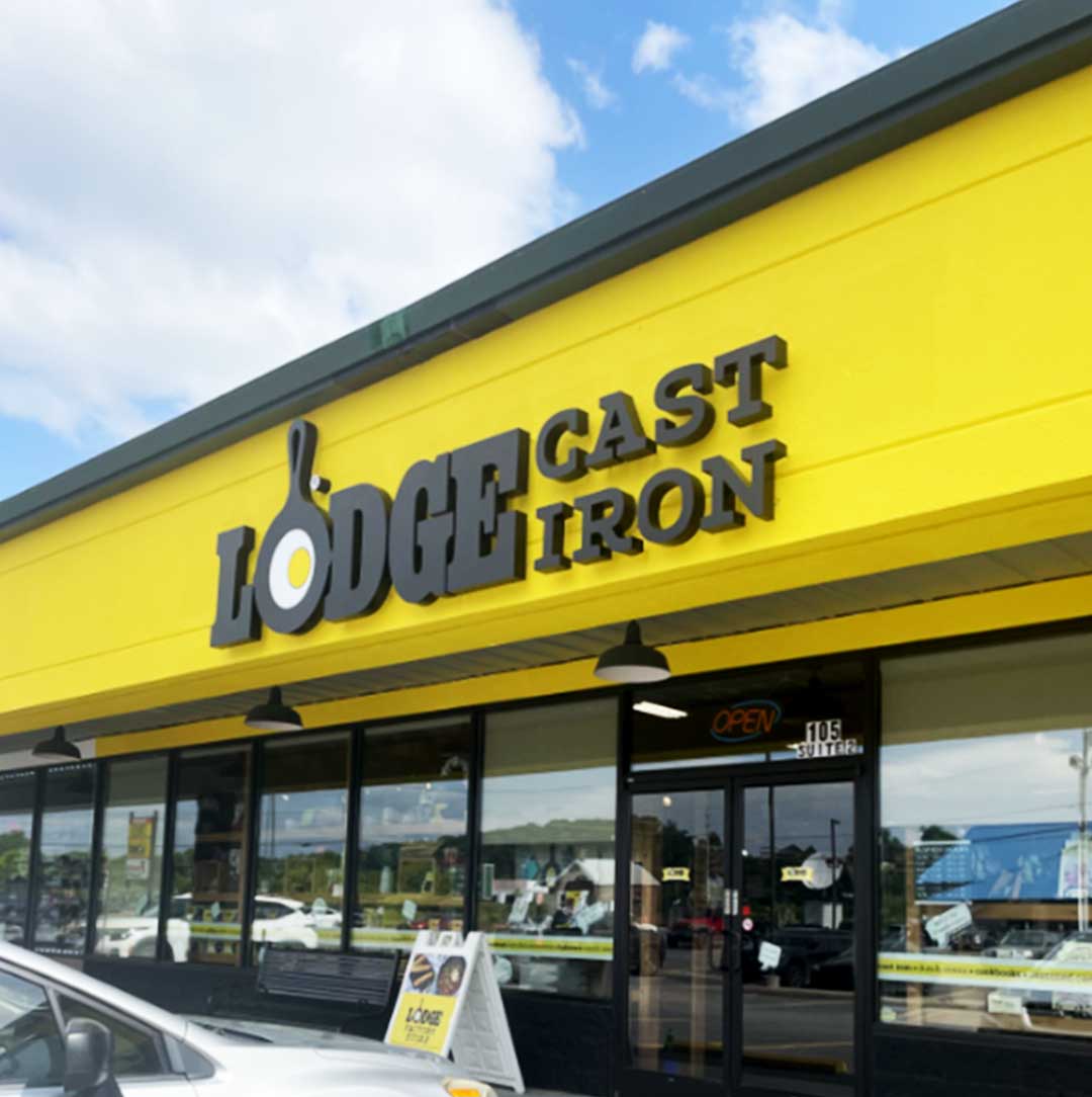 Storefront with 'Lodge Cast Iron' sign on a yellow background