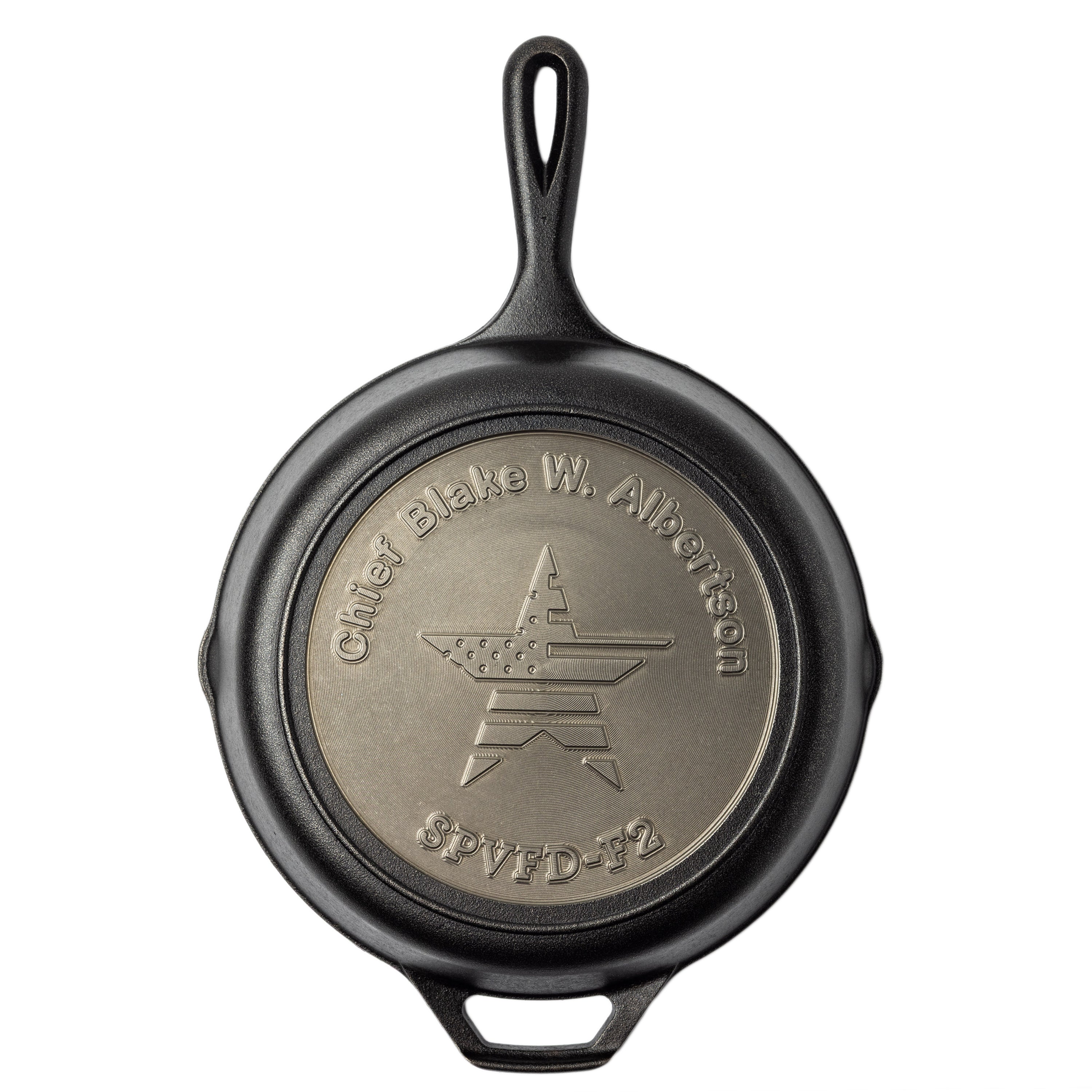 Black cast iron skillet with engraved design on a white background