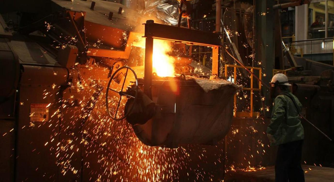 Foundry operation where workers manage molten metal material.