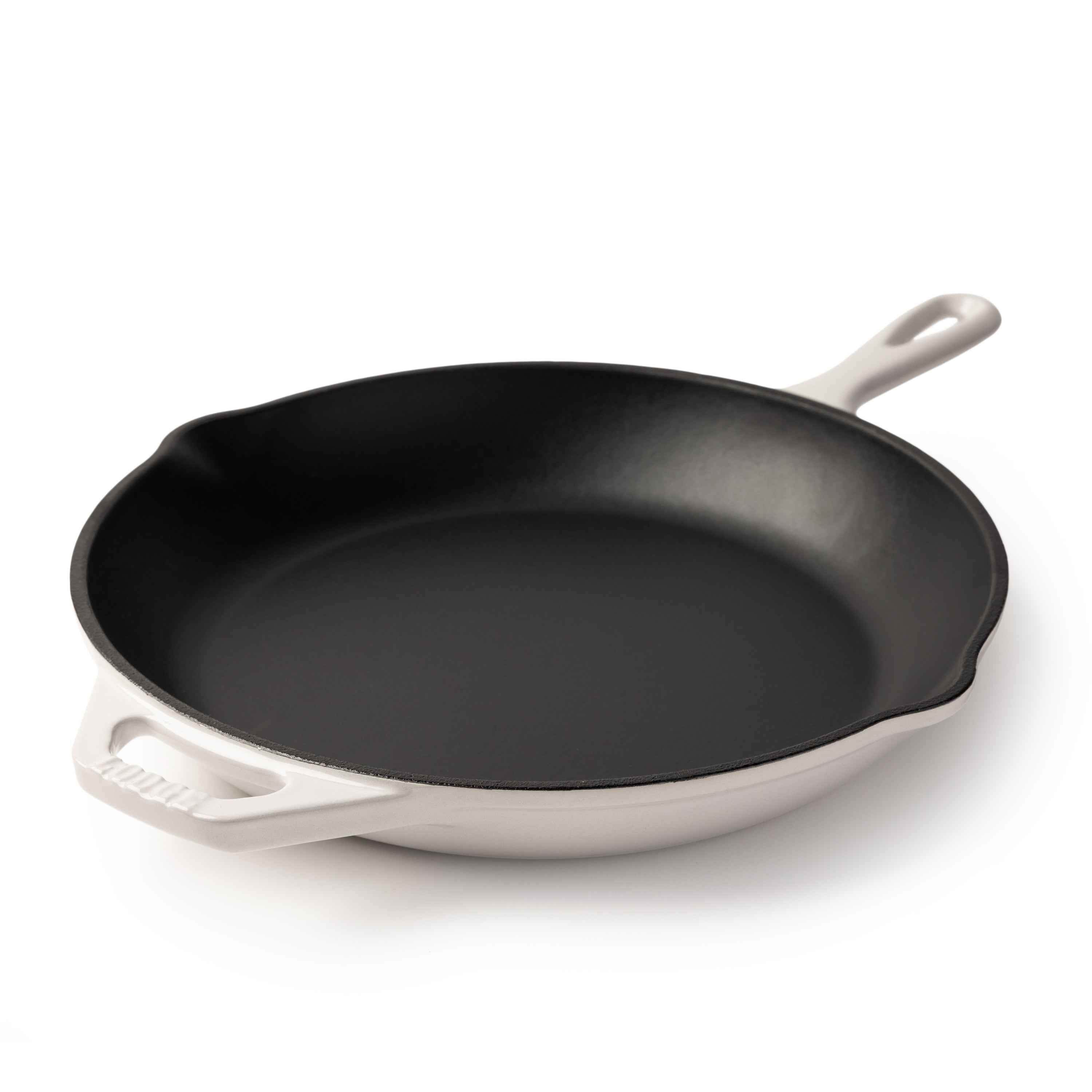 A cast iron skillet with a black interior and a white exterior, featuring a single loop handle on the right and a side handle on the left, photographed on a clean white background.