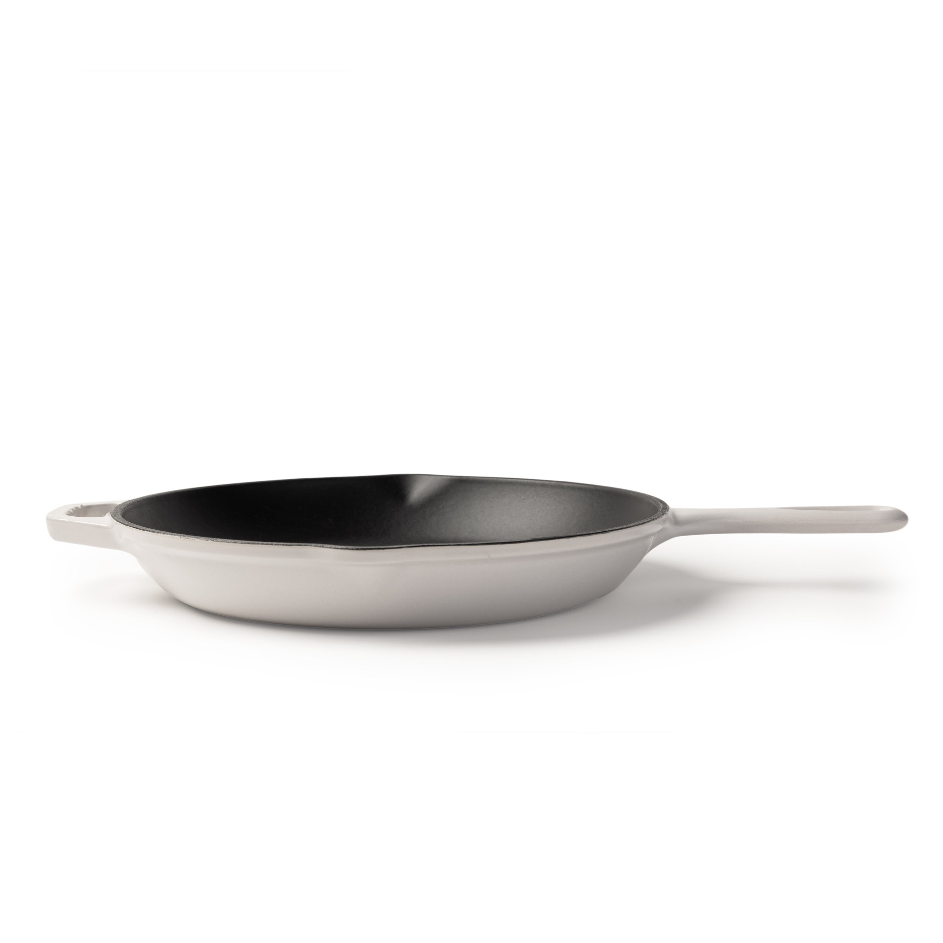 A white cast iron skillet with a black non-stick interior and a single white handle, shown on a clean white background.