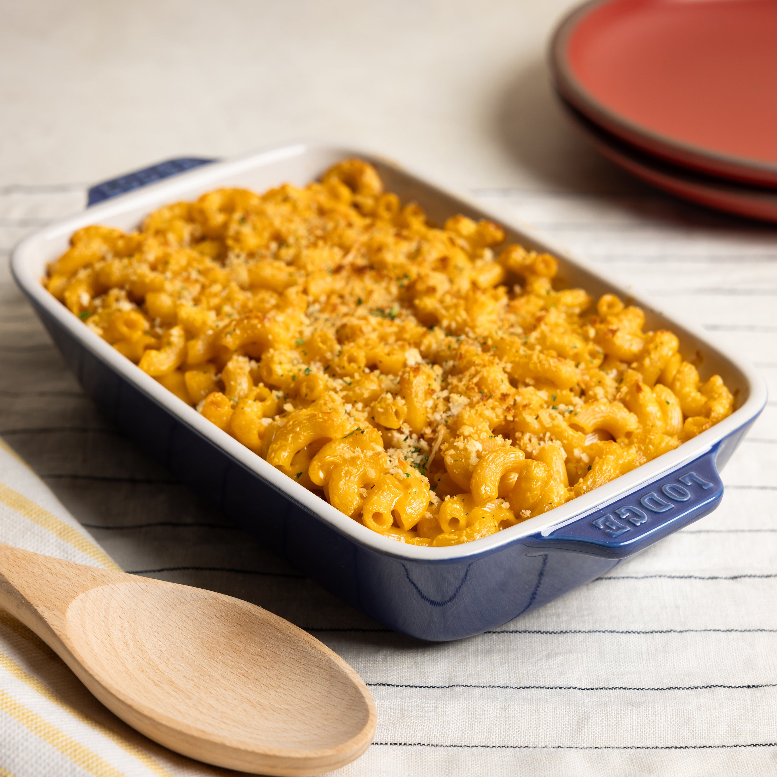 Macaroni and cheese in an indigo baking dish.