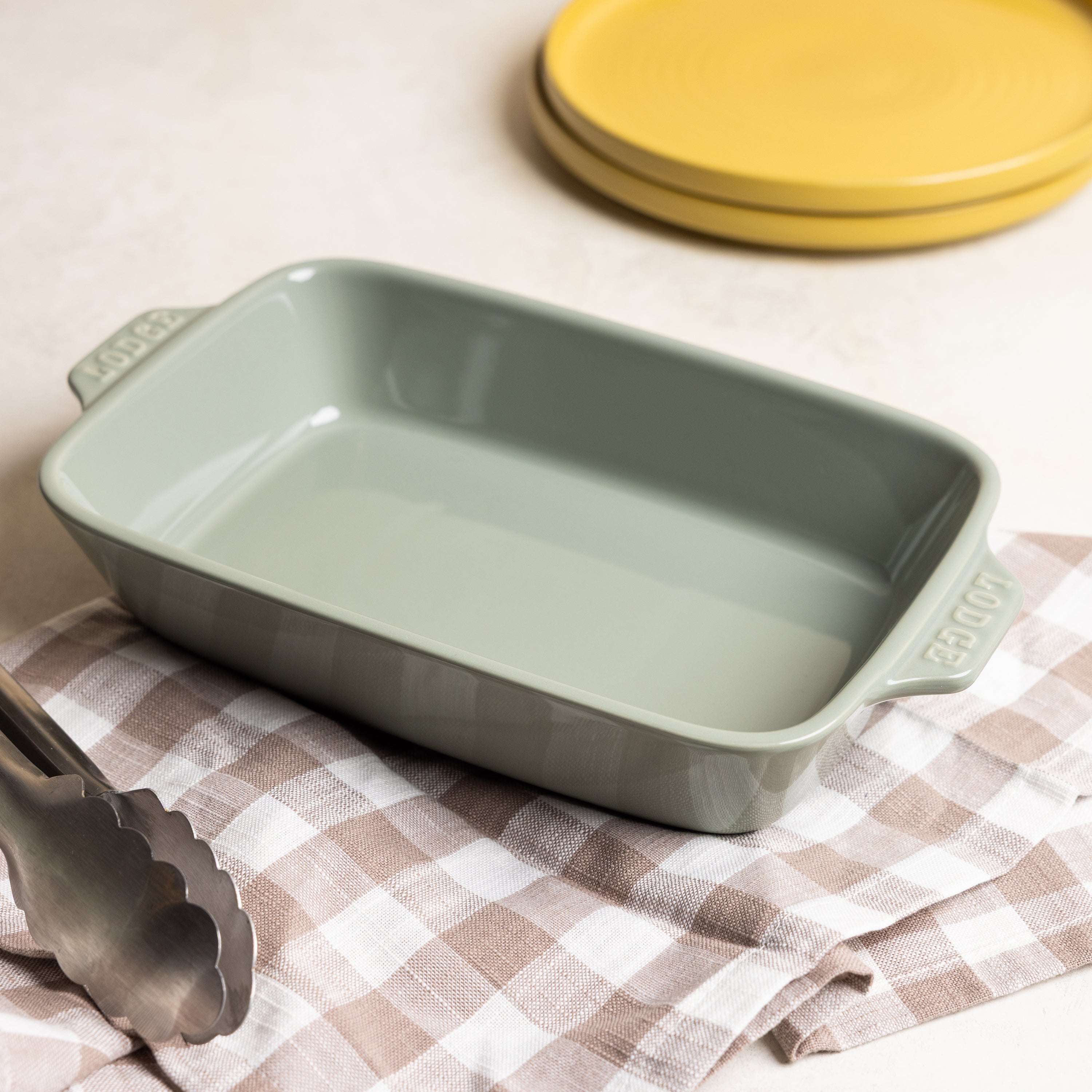 Desert-sage ceramic baking dish on a counter.