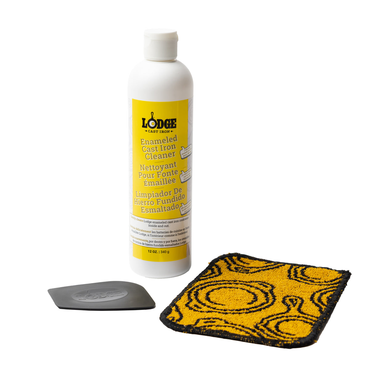 3 piece enamel cleaning set including a black and yellow scrub cloth, black pan scraper, and a 12 ounce bottle of enamel cleaner.