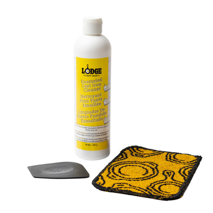 3 piece enamel cleaning set including a black and yellow scrub cloth, black pan scraper, and a 12 ounce bottle of enamel cleaner.