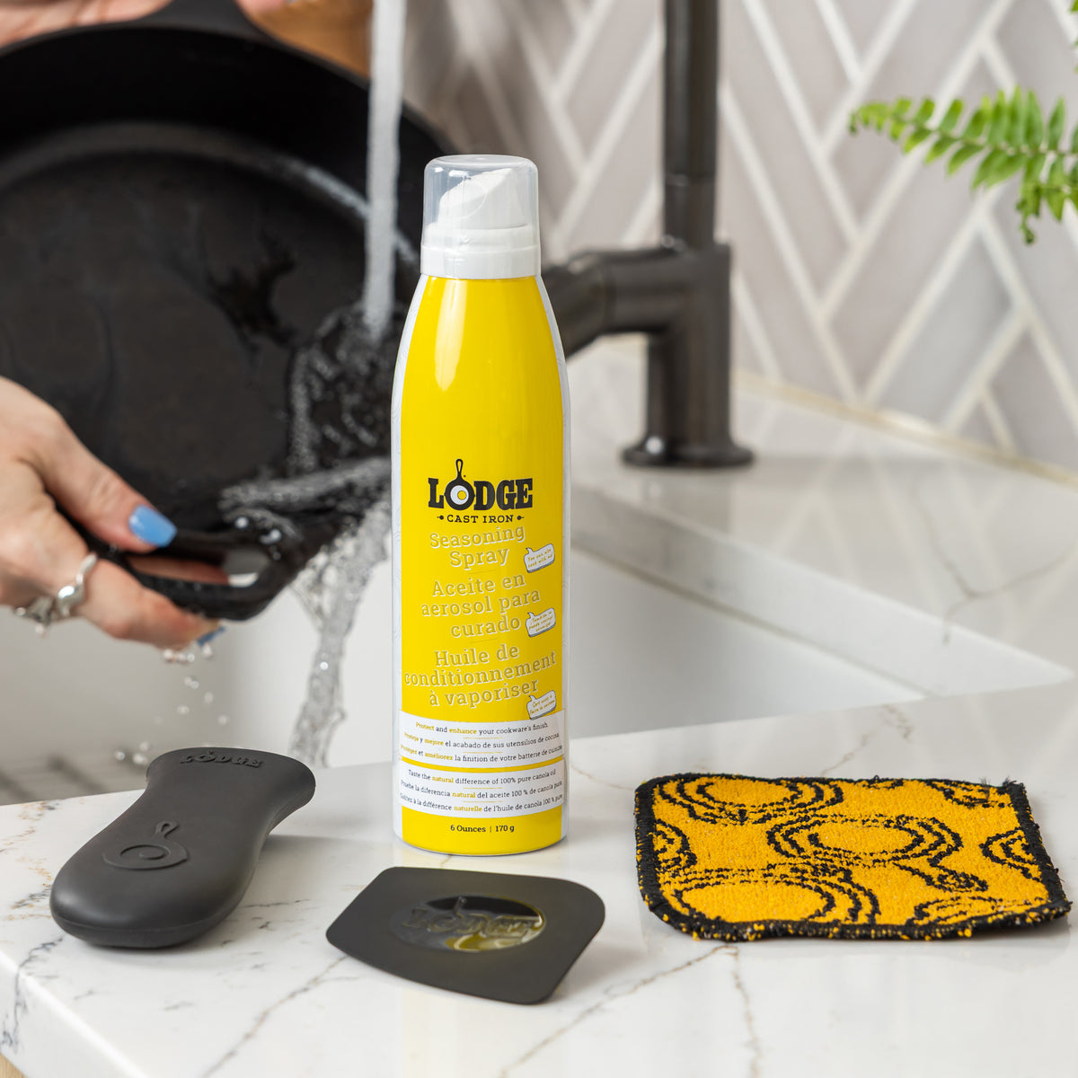 The care kit ready to use next to the sink as someone washes their cast iron skillet,