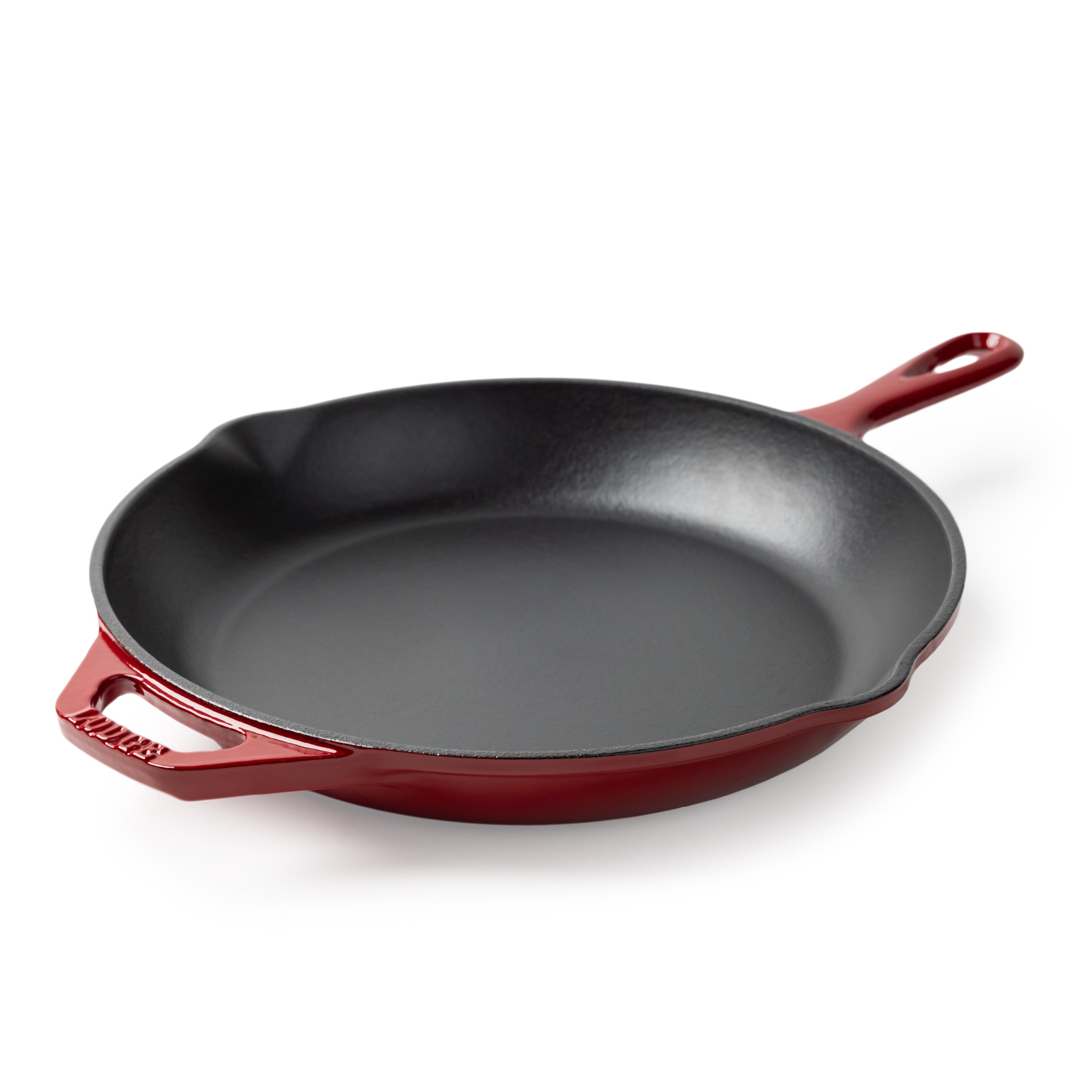 A Lodge enameled cast iron skillet with a black interior and a red exterior.