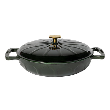 A dark green enameled cast iron lidded casserole dish with side handles, a gold-tone knob, and a sunburst pattern.