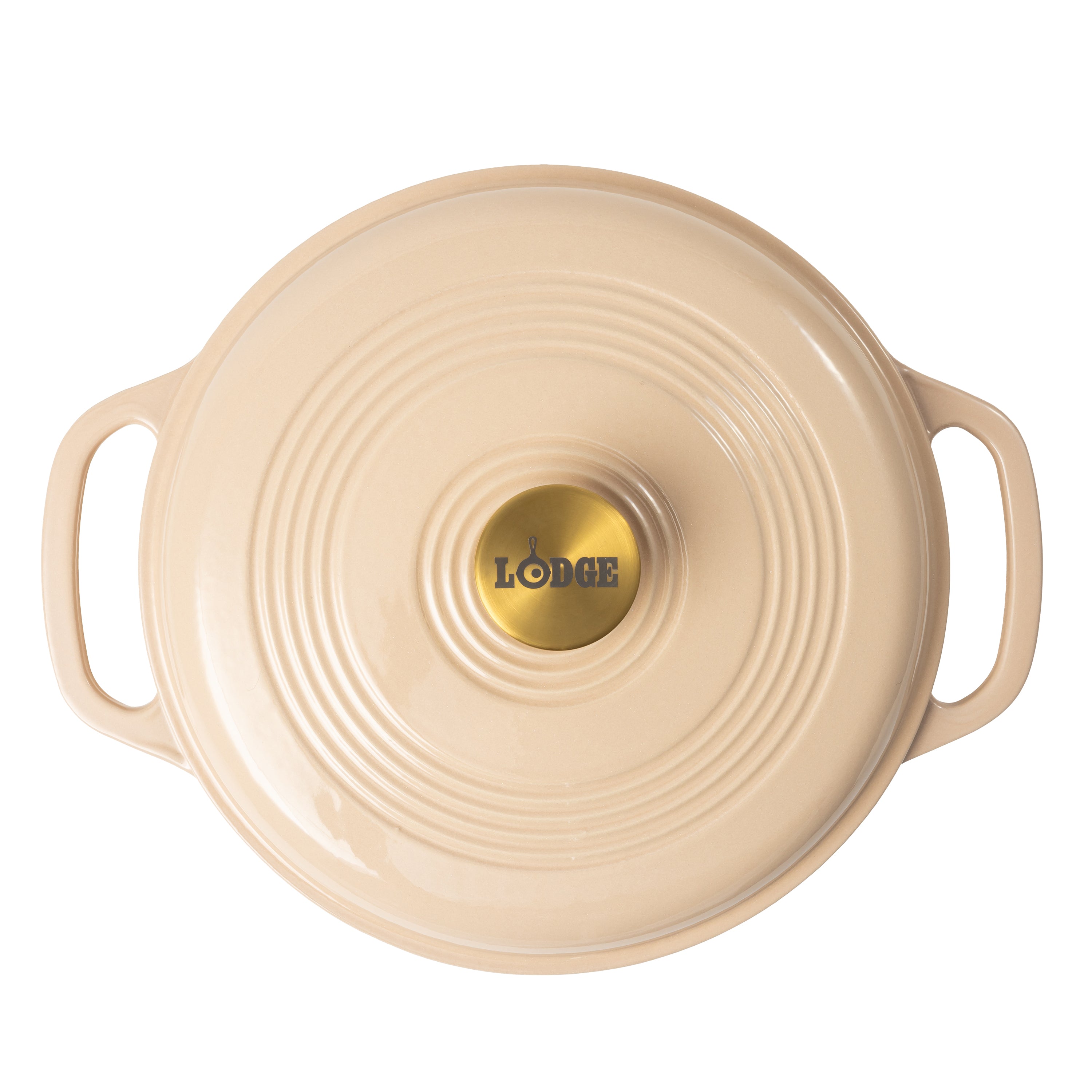 A cream colored Lodge cast iron Dutch oven shown from a top-down view, featuring a circular lid with concentric ridges, two side handles, and a gold-colored center knob with the Lodge logo.