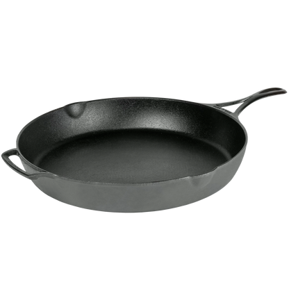 A classic black cast iron skillet with a long handle and a small side loop handle.
