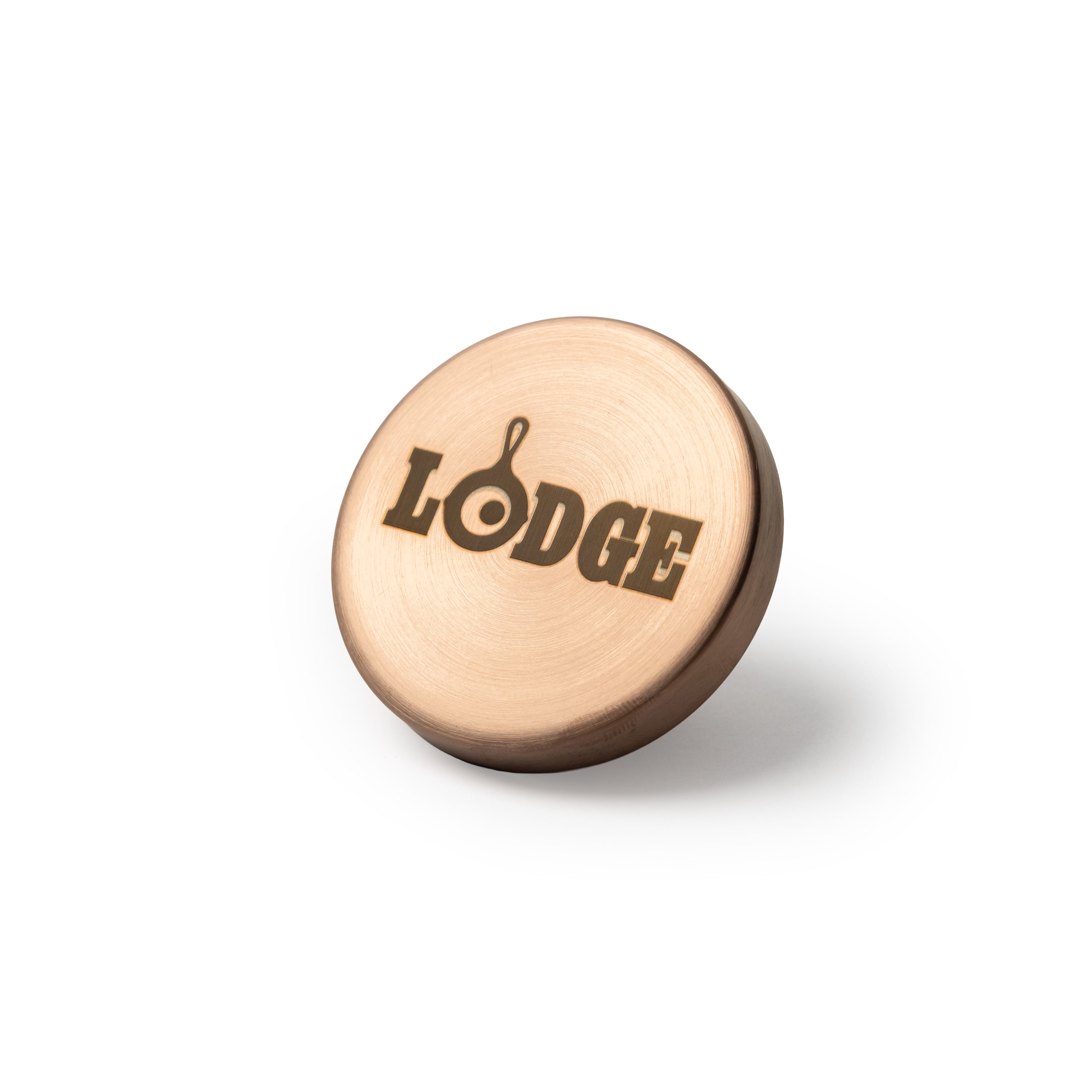 A round, copper colored knob engraved with the word 'LODGE'.