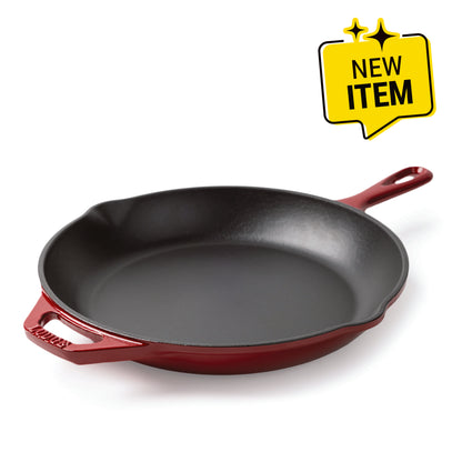 A Lodge enameled cast iron skillet with a black interior and a red exterior, shown on a white background with a yellow 'NEW ITEM' badge in the top right corner.
