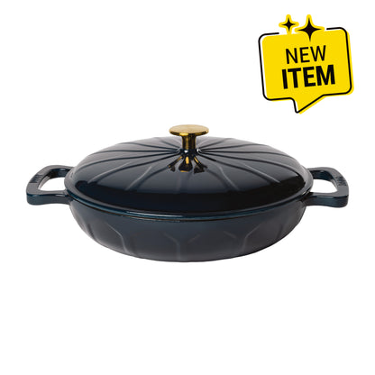 A dark navy blue enameled cast iron lidded casserole dish with side handles, a gold-tone knob, and a sunburst pattern. A badge saying "New Item" is displayed in top corner.