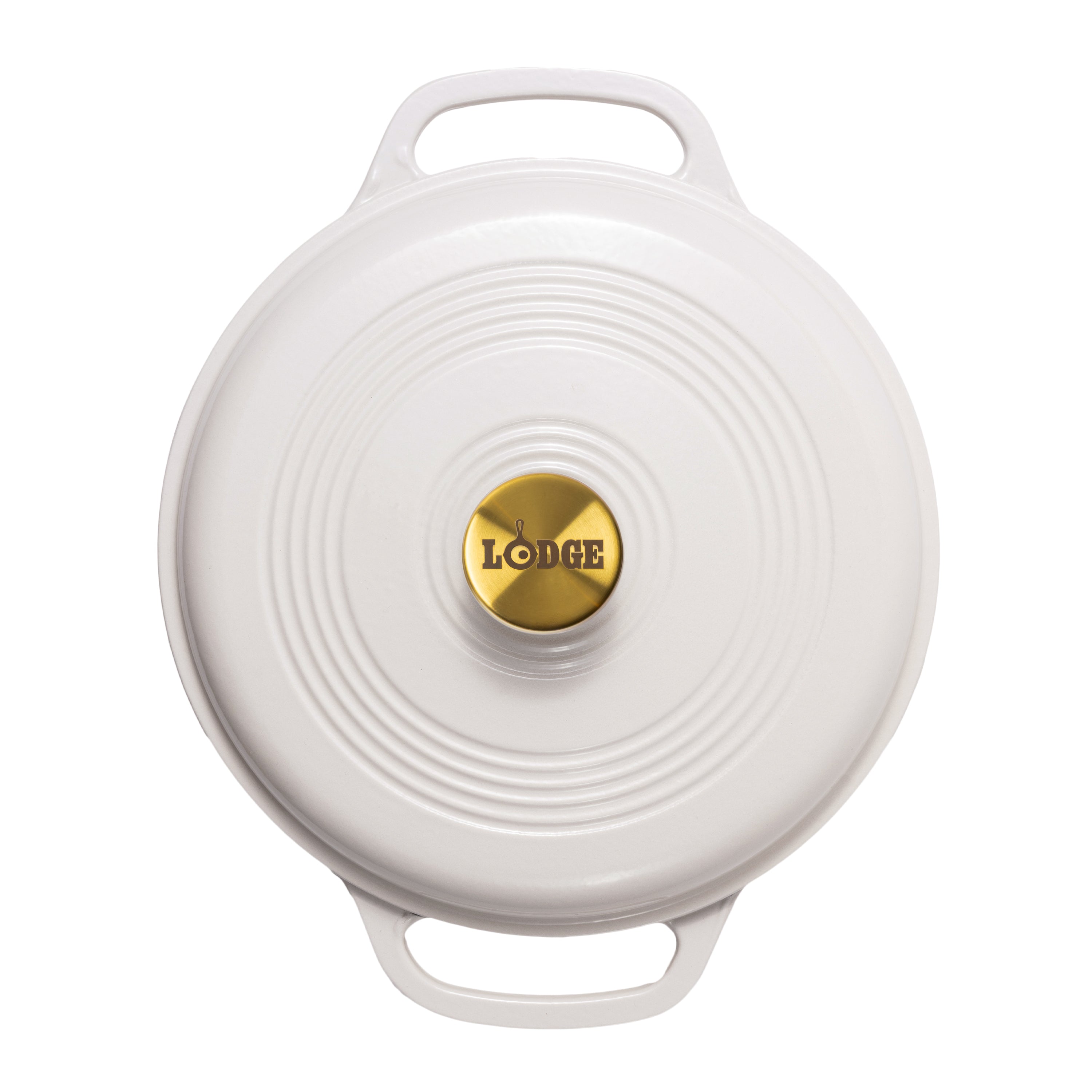 A top-down view of a white Lodge round cast iron Dutch oven lid with two handles and a gold center knob.