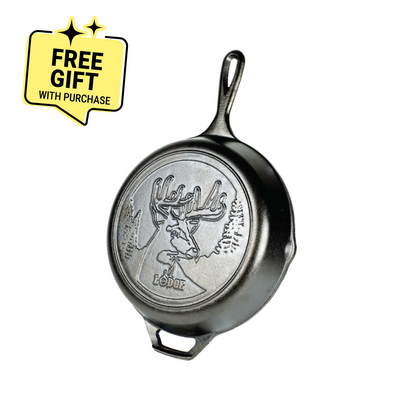 Cast iron skillet with embossed design featuring a deer with antlers in a forest. Featuring a badge saying "Free Gift with Purchase".