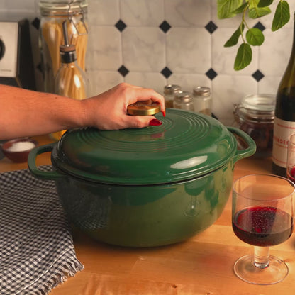 Someone removing lid from dutch oven revealing fresh stew.