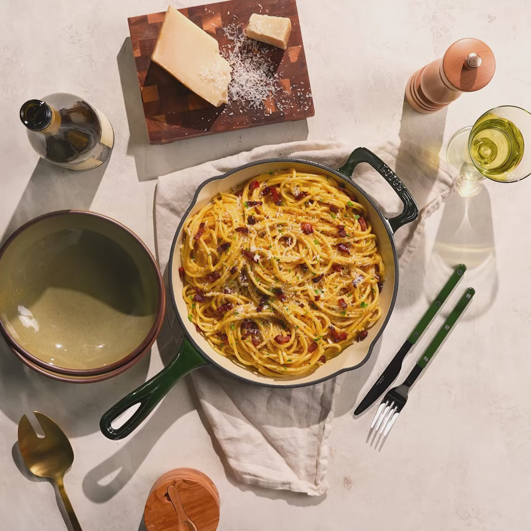 Skillet placed on counter with freshly made pasta.