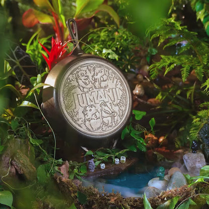 Close up view of skillet in a jungle with a stream of water and game pieces nearby.