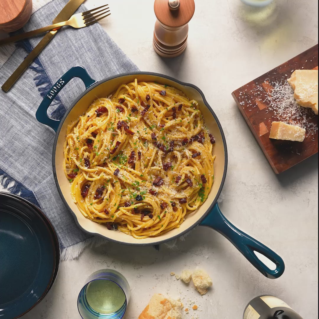 Skillet placed on counter with freshly made pasta.