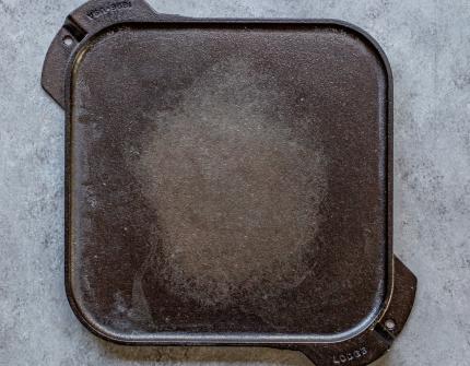 I was cleaning my dutch oven after a routine use and noticed the enamel  coating was flaking (cast iron not exposed). Is it still safe to use? Can  this be fixed? 
